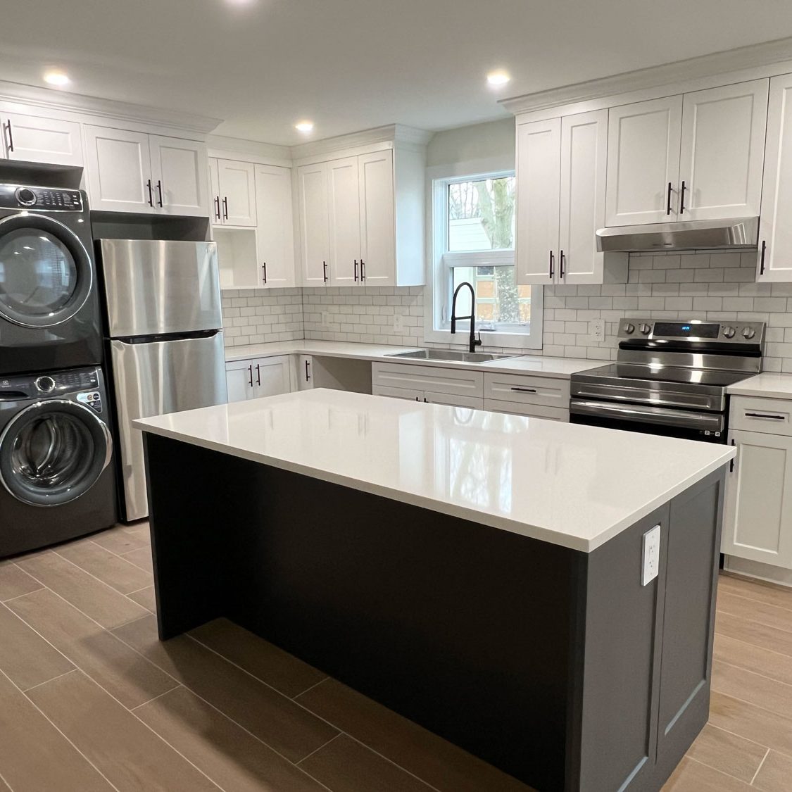 white kitchen with a black island