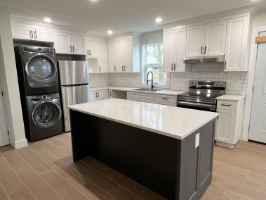 white kitchen with a black island