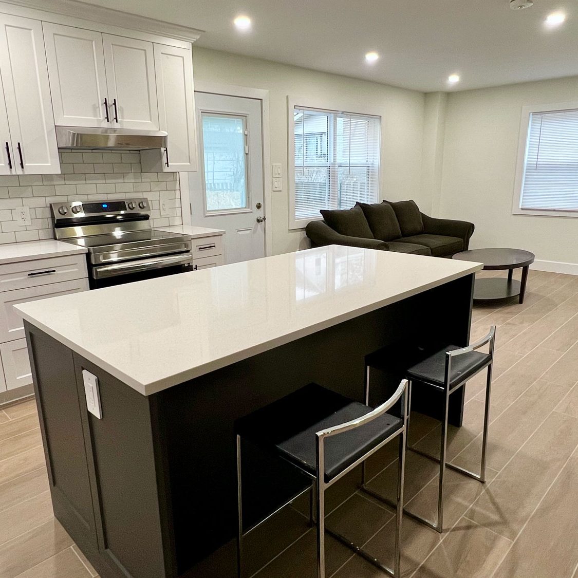 white kitchen with a black island