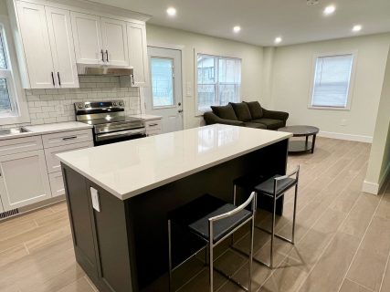 white kitchen with a black island