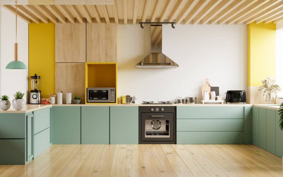 a modern kitchen with yellow and green cabinets