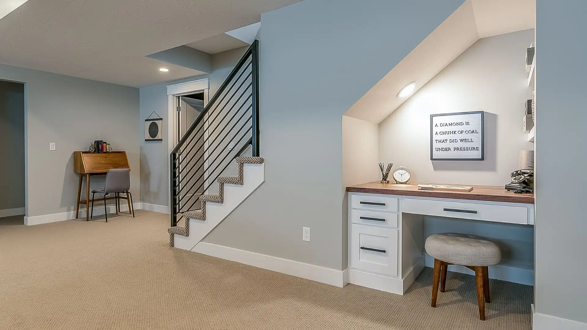 basement-renovation-1 a home office with a desk and stairs in a newly renovated basement