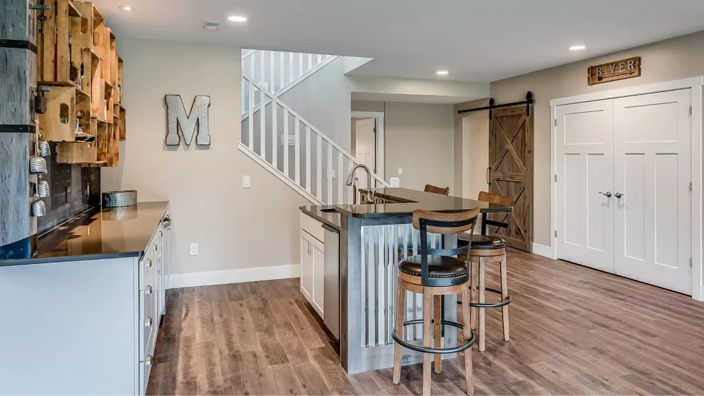 a kitchen and dining area in a newly renovated basement with hardwood floors