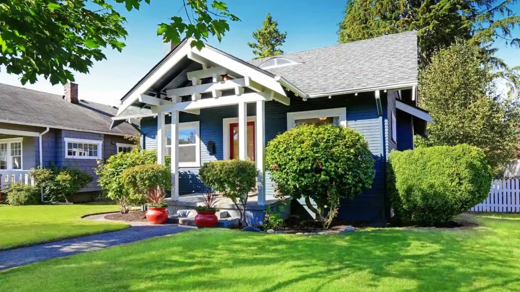 a blue house with green grass in front of it