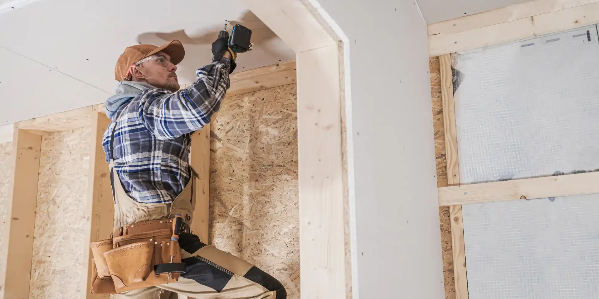 home-renovation-winters-1 contractor working on a ceiling during renovations