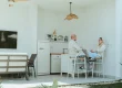 Couple taliking and sitting on their outdoor kitchen