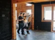 A couple standing in an unfinished house.
