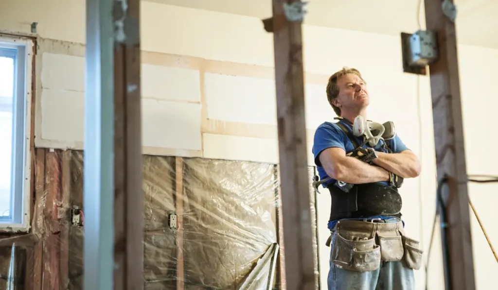 a builder looking up at the ceiling,