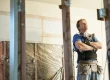 a builder looking up at the ceiling,