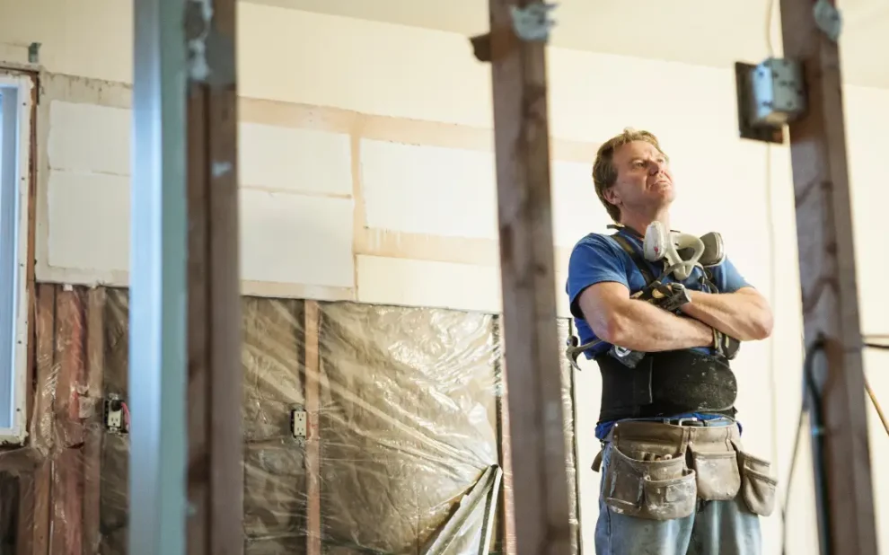 a builder looking up at the ceiling,