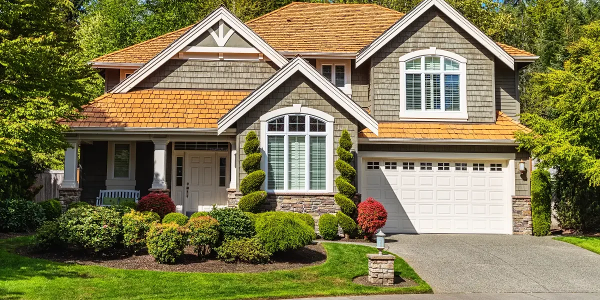 hst-rebate-custom-homes-1 Luxury custom home exterior with landscaped front yard and driveway