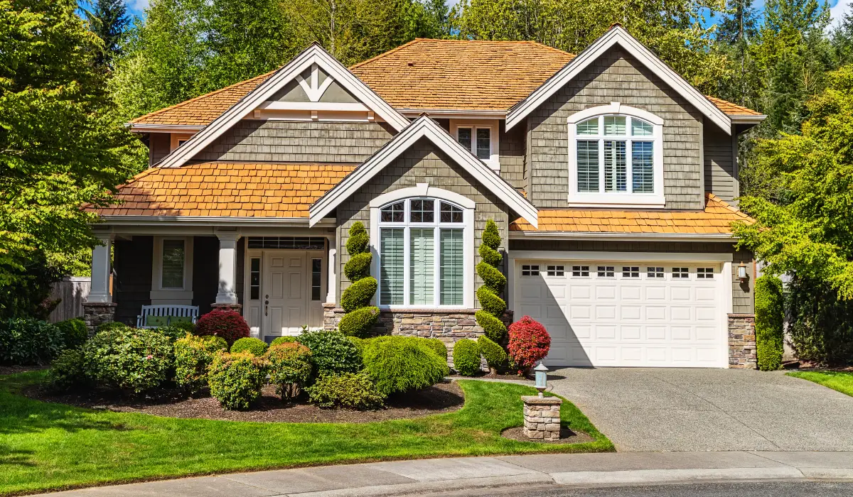 Luxury custom home exterior with landscaped front yard and driveway